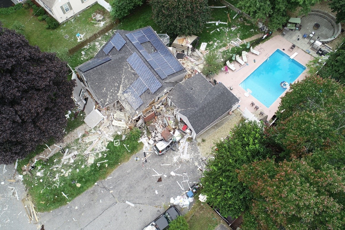 Aerial view of damaged home where a fatality occurred after the chimney collapsed.