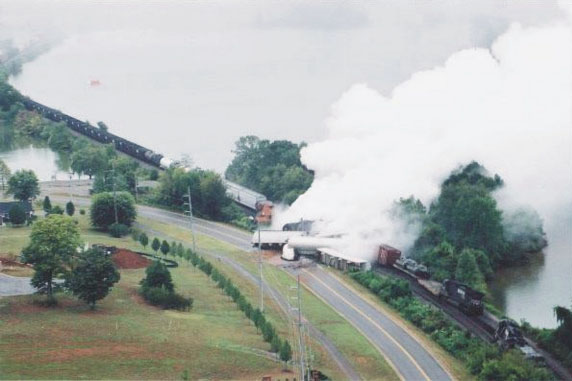 Photo looking east at the derailment of NS train 15T showing fuming sulfuric acid from ruptured tank car.