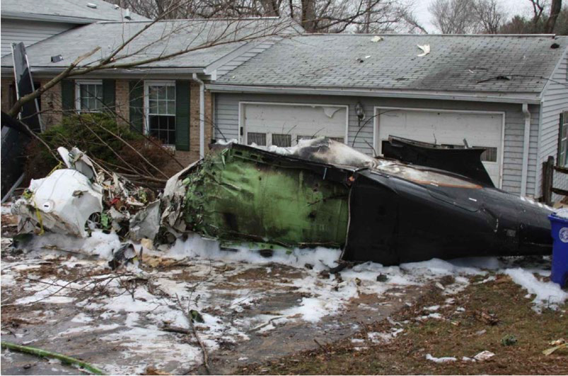 Photograph of the fuselage showing impact and fire damage to house B.