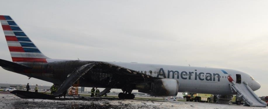Photo of right side of airplane after uncontained engine failure and subsequent fire.