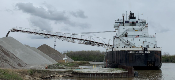 John J Boland discharging cargo from its port side using its self-unloading boom in Lorain, Ohio, after the grounding.