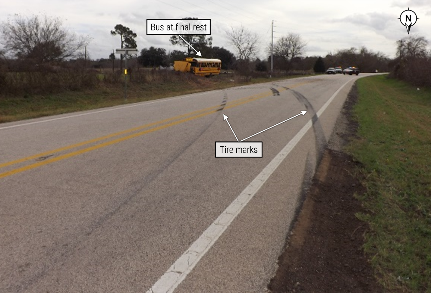 South-facing view from shoulder of Farm to Market Road 1887 showing final rest position of school bus. 