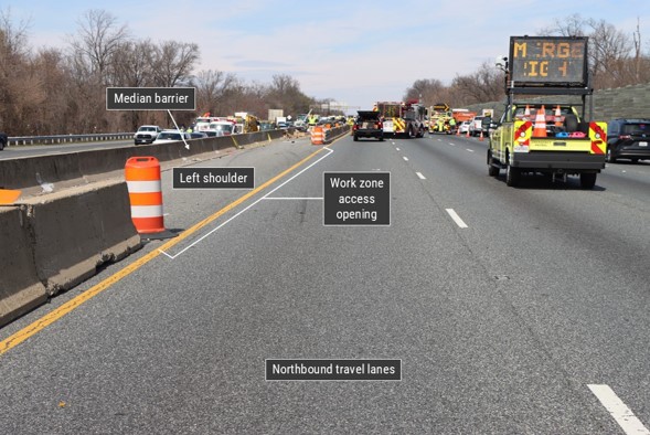 Postcrash view of the work zone showing the barrier opening through which the Acura entered. Emergency vehicles are present on 