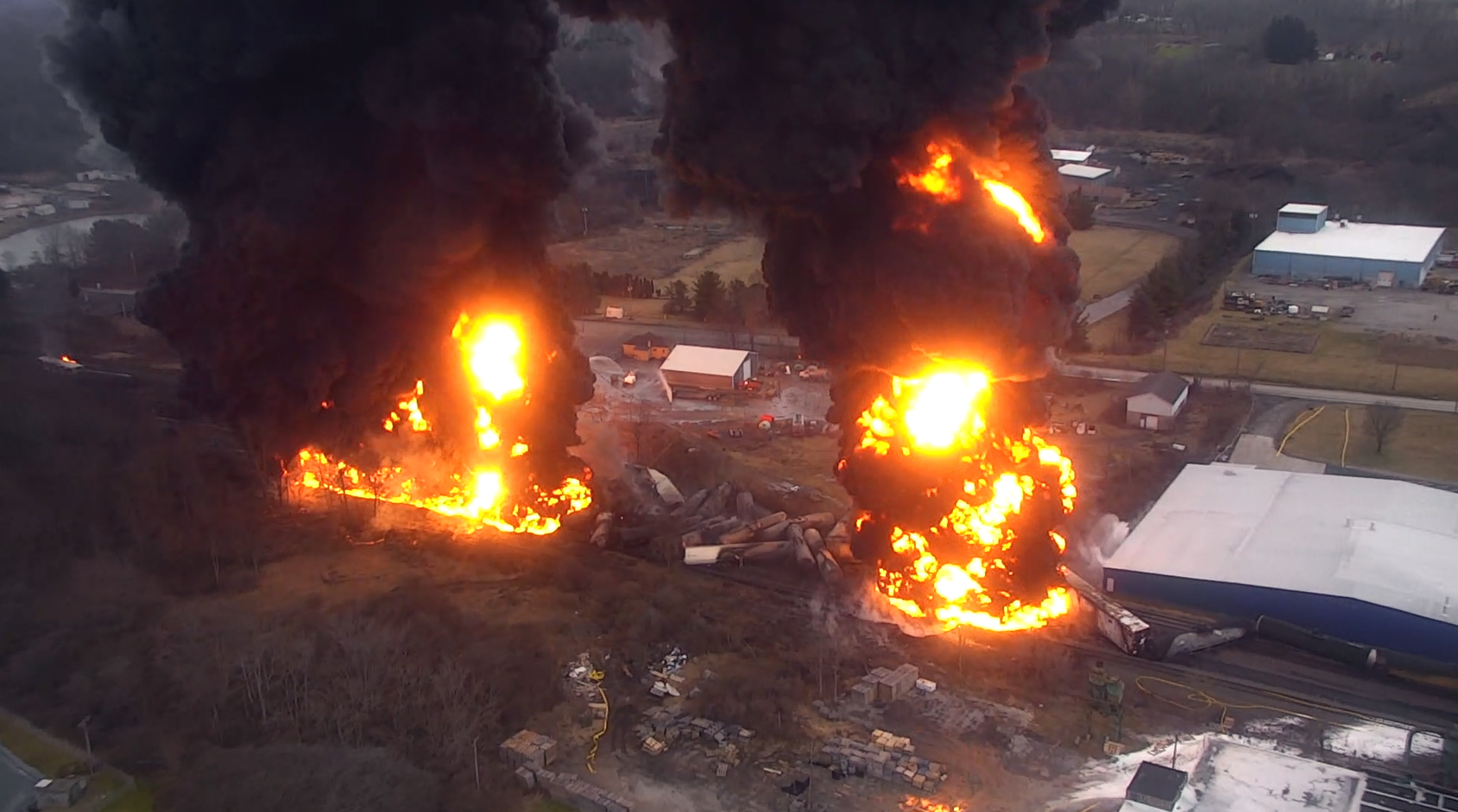 aerial view of the accident scene, derailed train, and subsequent hazardous material release and fires. 